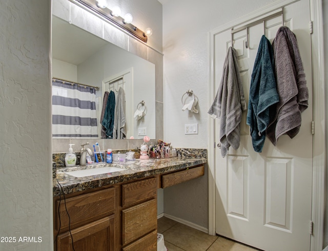 bathroom featuring tile patterned flooring and vanity