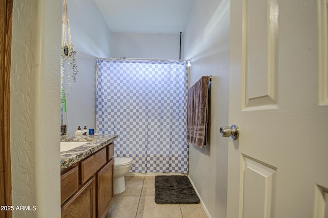 bathroom featuring vanity, tile patterned floors, and toilet