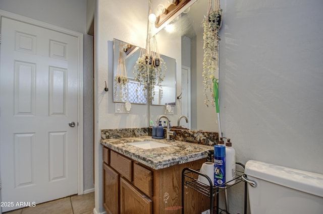 bathroom with vanity, tile patterned flooring, and toilet