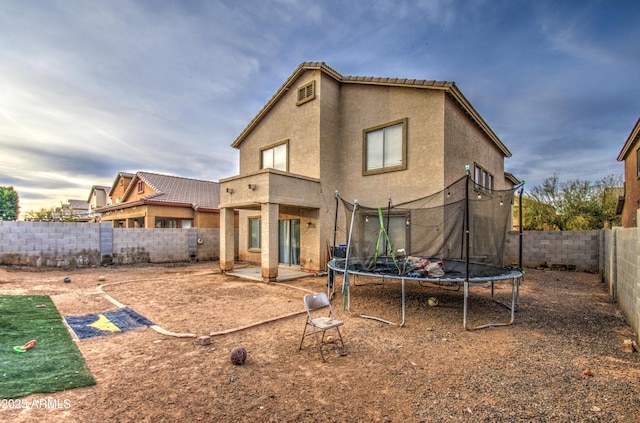 back of property with a trampoline