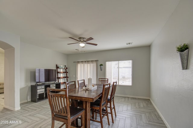 dining space featuring ceiling fan and light parquet flooring