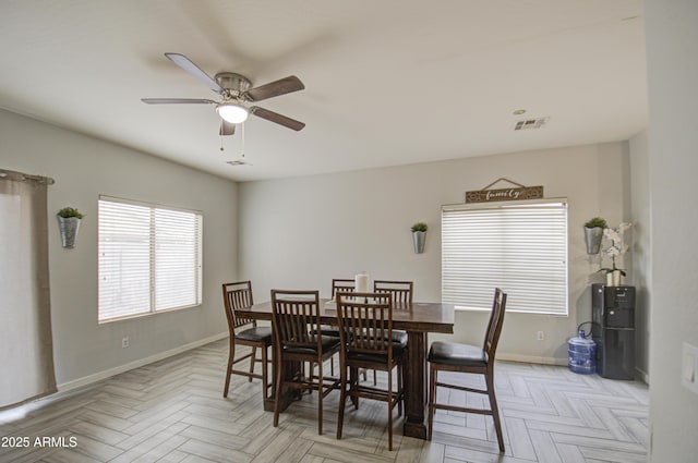 dining space featuring ceiling fan and light parquet floors