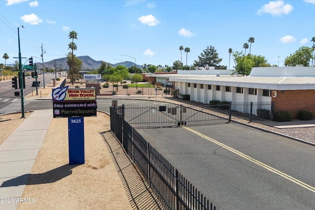 11621 N 39th Dr, Phoenix, AZ 85029 - view of street with street lighting, a mountain view, sidewalks, and a gate