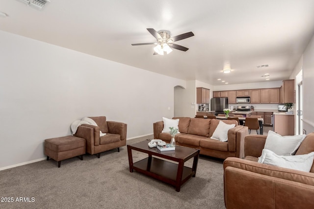 carpeted living room with ceiling fan