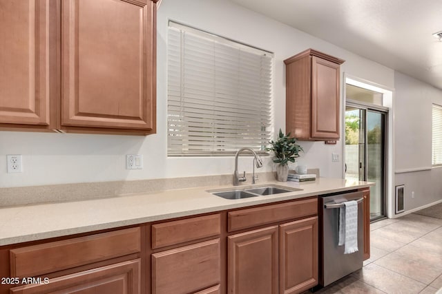 kitchen featuring sink, stainless steel dishwasher, and light tile patterned flooring