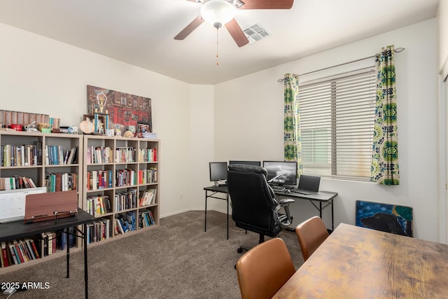 carpeted office space featuring ceiling fan