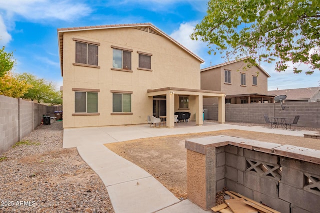 rear view of property featuring a patio