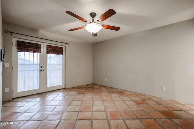 spare room featuring ceiling fan and french doors