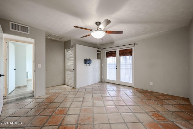 empty room featuring ceiling fan and french doors