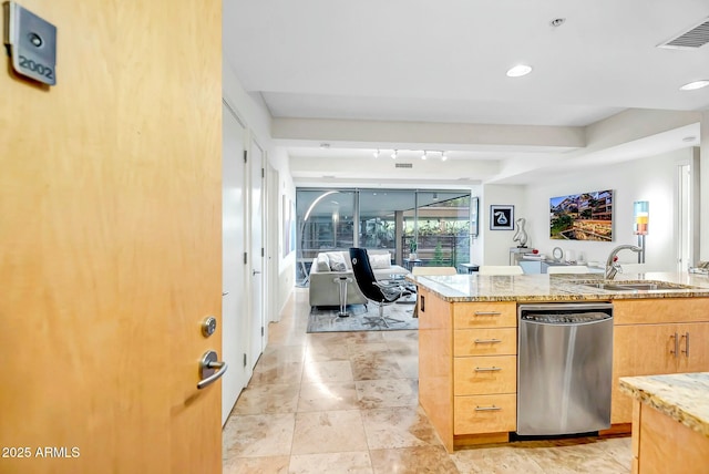 kitchen with light stone counters, recessed lighting, a sink, visible vents, and dishwasher