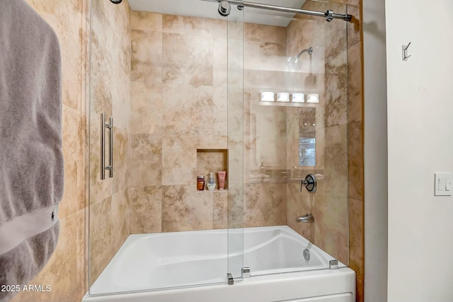 bathroom with shower / bath combination with glass door