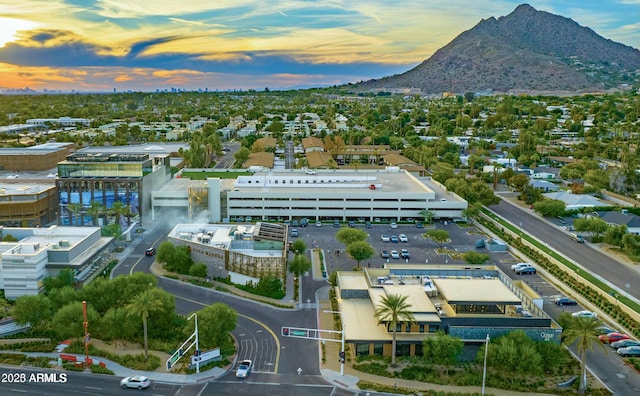 aerial view at dusk featuring a mountain view