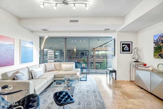 living room with rail lighting, baseboards, and visible vents