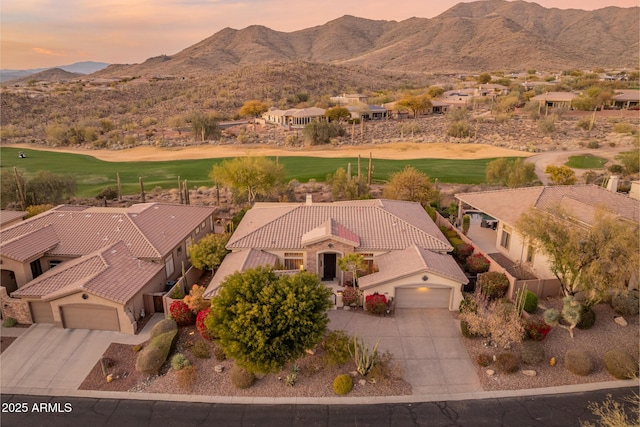 aerial view at dusk featuring a mountain view