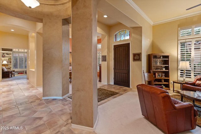 entryway featuring crown molding and a high ceiling