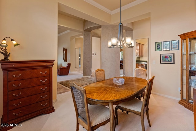 dining space with crown molding, light colored carpet, and a chandelier