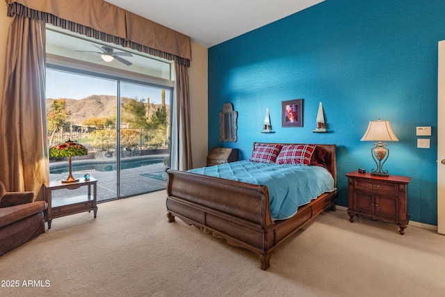 carpeted bedroom with a mountain view and access to outside