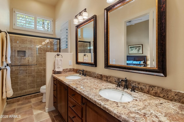 bathroom with vanity, toilet, and a shower with door