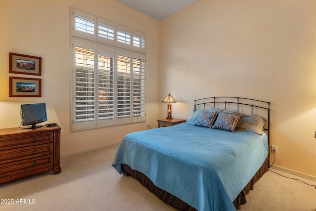 bedroom featuring light colored carpet