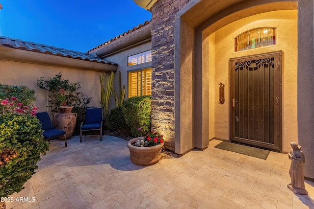 property entrance with a patio