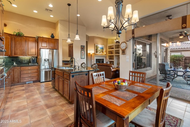 dining room featuring light tile patterned flooring, ceiling fan, and sink