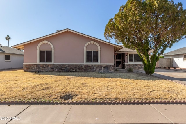 ranch-style house with a front lawn