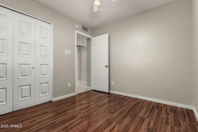 14408 N 35th Ave, Phoenix, AZ 85053 - unfurnished bedroom featuring ceiling fan, dark hardwood / wood-style floors, and a closet