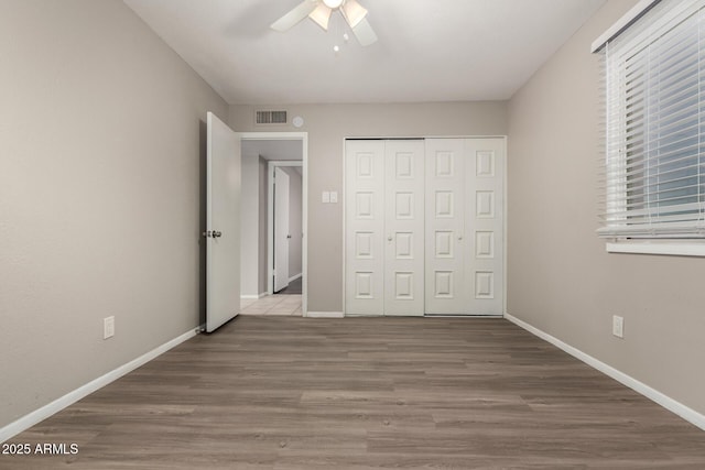 14408 N 35th Ave, Phoenix, AZ 85053 - unfurnished bedroom with ceiling fan, a closet, and light wood-type flooring