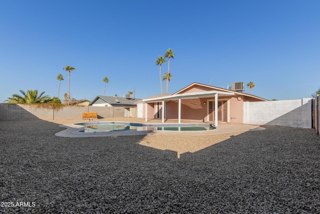 14408 N 35th Ave, Phoenix, AZ 85053 - rear view of house featuring a fenced in pool, central AC unit, and a patio area