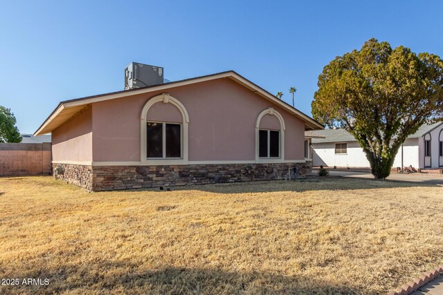 14408 N 35th Ave, Phoenix, AZ 85053 - back of property featuring a yard and central AC unit