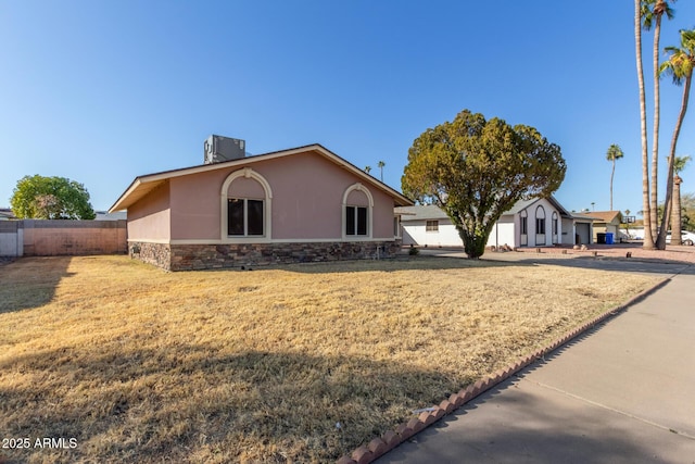 14408 N 35th Ave, Phoenix, AZ 85053 - view of front of house featuring central AC and a front lawn
