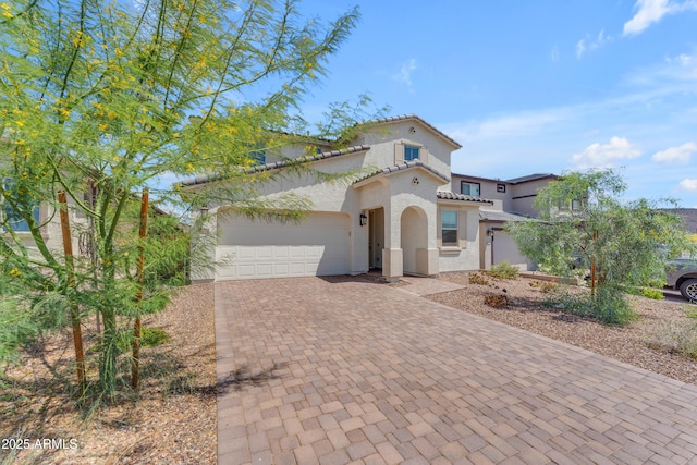 12370 W Cassia Trl, Peoria, AZ 85383 - mediterranean / spanish-style house featuring decorative driveway, stucco siding, an attached garage, and a tiled roof