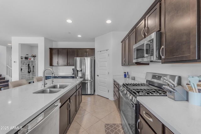 12370 W Cassia Trl, Peoria, AZ 85383 - kitchen with stainless steel appliances, a sink, dark brown cabinets, light countertops, and recessed lighting