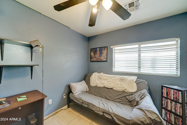 sitting room with ceiling fan, tile patterned flooring, and visible vents