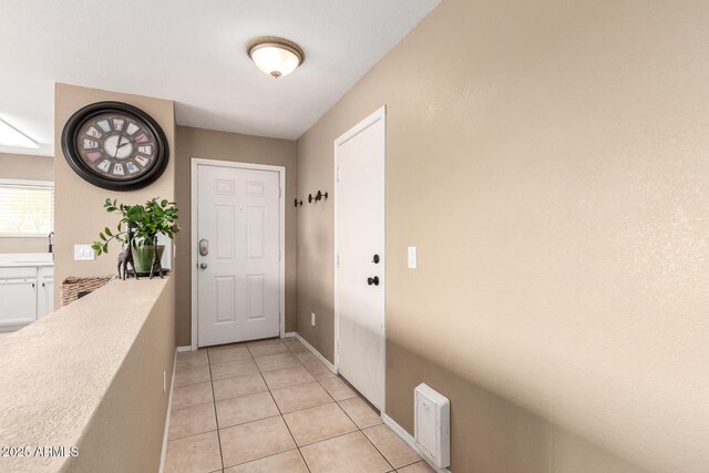 kitchen featuring light tile patterned floors, stainless steel appliances, a sink, visible vents, and light countertops