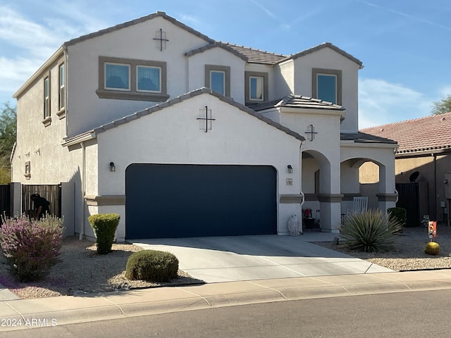 mediterranean / spanish house with a garage