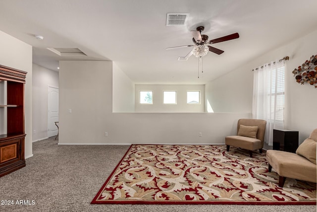 living area with ceiling fan, carpet, and a healthy amount of sunlight