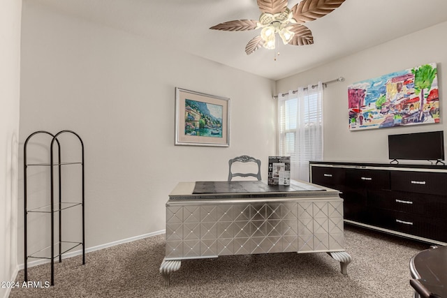 carpeted office space featuring ceiling fan