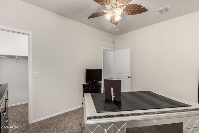 carpeted office with ceiling fan