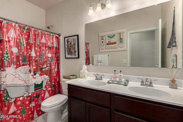 bathroom featuring curtained shower, vanity, and toilet