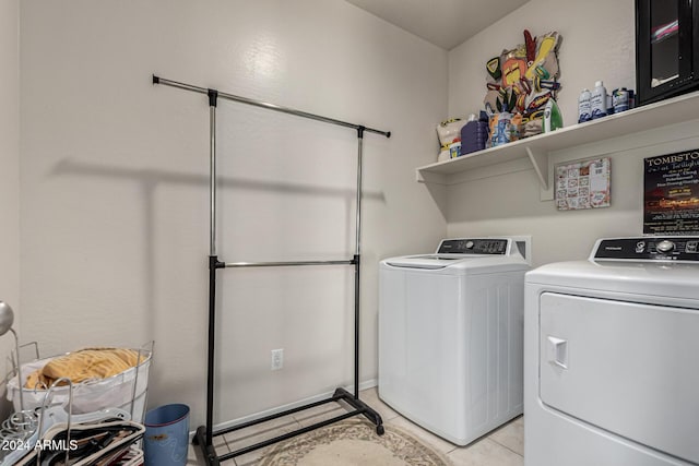 washroom with washer and dryer and light tile patterned flooring