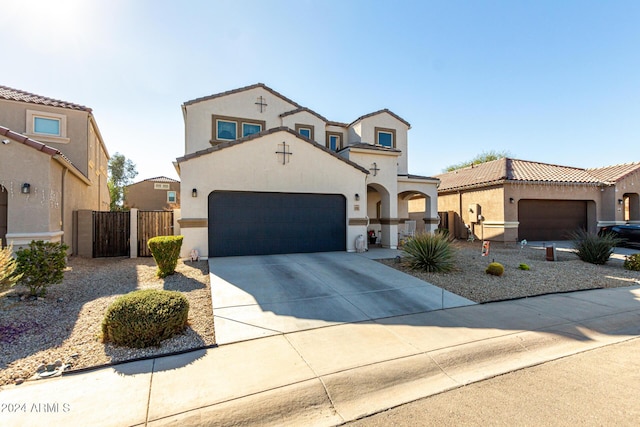 mediterranean / spanish-style house with a garage