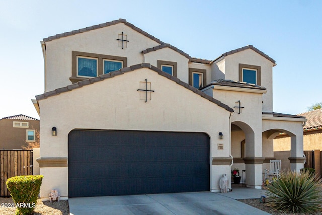 mediterranean / spanish house with a garage