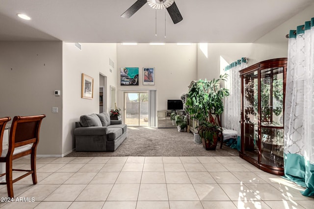 carpeted living room with ceiling fan