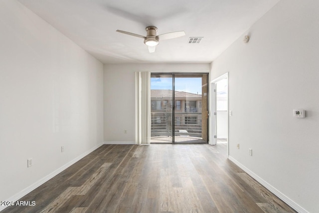 unfurnished room featuring dark hardwood / wood-style floors and ceiling fan