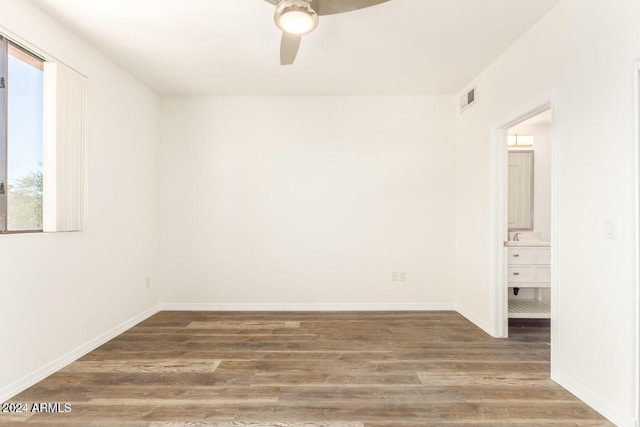 empty room featuring ceiling fan and dark hardwood / wood-style floors