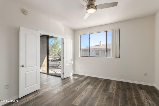 empty room featuring ceiling fan and dark wood-type flooring