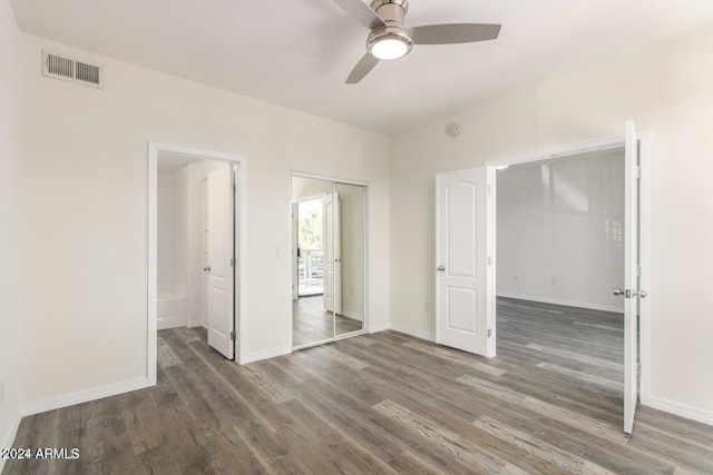 unfurnished bedroom featuring ceiling fan and dark hardwood / wood-style floors