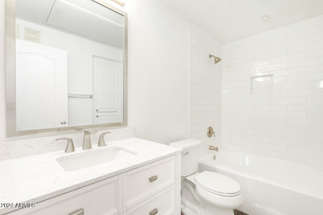 full bathroom with vanity, tiled shower / bath combo, and toilet