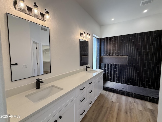 81 E Smoke Tree Rd, Gilbert, AZ 85296 - full bathroom with double vanity, wood finished floors, a tile shower, and recessed lighting